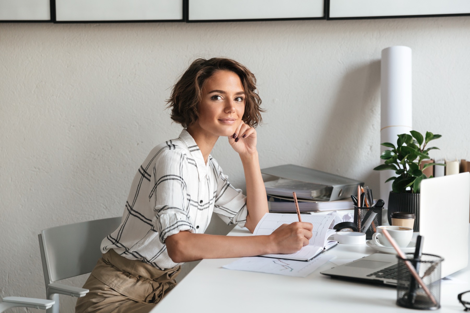 Woman sitting confidently at her workspace